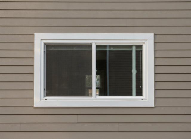 A slider glides sideways — no lifting, low profile, half the window opens.
